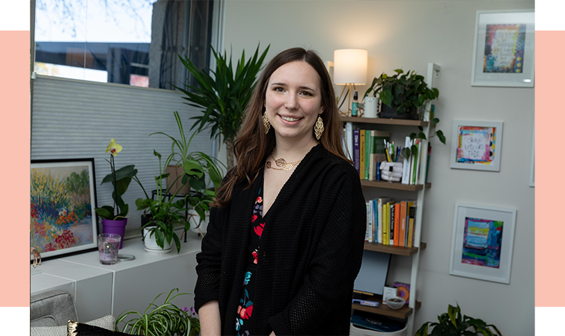 Our-Team_Ellen Ellen standing in office with plants and books
